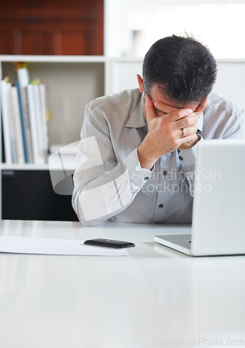 Image of Businessman, laptop and stress or depression at office, tired and fatigue for technology. Mature man, frustrated and fear for debt, problem and issues or bad investment, market crash and bankrupt