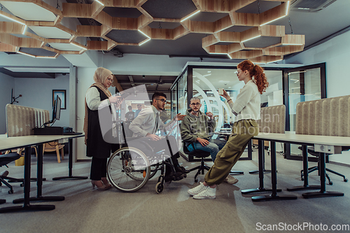 Image of Young group of business people brainstorming together in a startup space, discussing business projects, investments, and solving challenges.