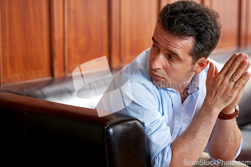 Image of Man, stress and thinking on sofa in waiting room for interview, recruitment or loss of job. Businessman, anxiety or sitting on couch with fear for unemployment, failure or problem with hiring at work