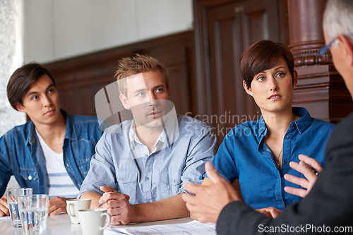 Image of Business meeting, team and mentor with listening for planning, strategy or brainstorming in office. Employees, men and woman with partnership, collaboration or documents and discussion at workplace