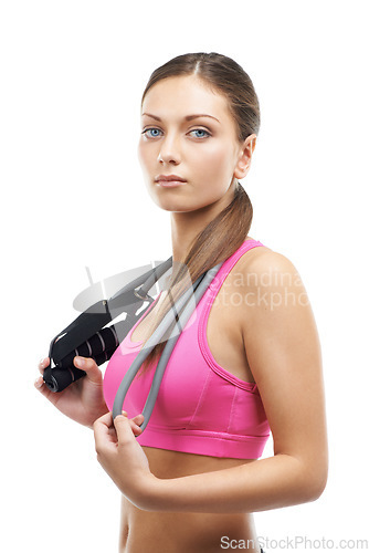 Image of Fitness, skipping rope and portrait of woman on a white background for workout, exercise and training. Serious, performance and person with gym equipment for sports, wellness and health in studio