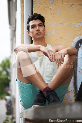 Image of Man, relax and thinking or chilling, wall and outdoors for fashion, cool and trendy or stylish for confidence. Filipino male person, calm and resting on vacation, holiday and travelling to Mexico