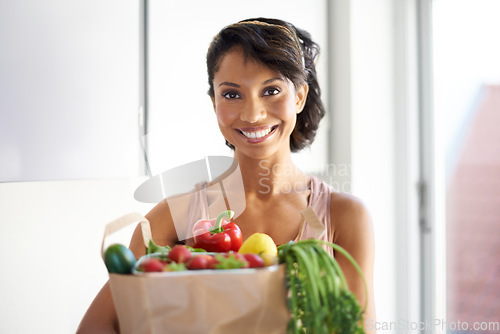 Image of Happy woman, portrait and shopping bag in kitchen with groceries, vegetables or fresh produce at home. Female person, shopper or vegan smile with food from grocery for salad or healthy diet at house