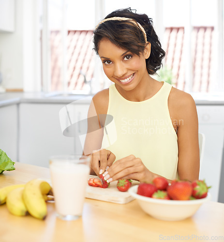 Image of Portrait, strawberry and fruit salad with a woman in the kitchen of her home for health, diet or nutrition. Smile, food and weight loss with a young person in her apartment for meal preparation