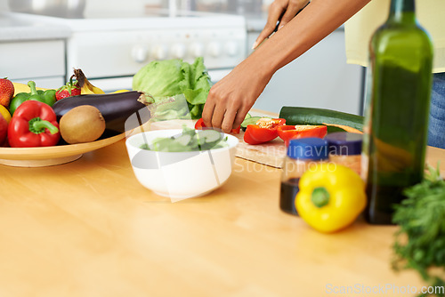 Image of Hands, food and salad with a person in the kitchen of a home closeup for health, diet or nutrition. Cooking, bowl and ingredients for a vegetarian meal with an adult in an apartment for dinner