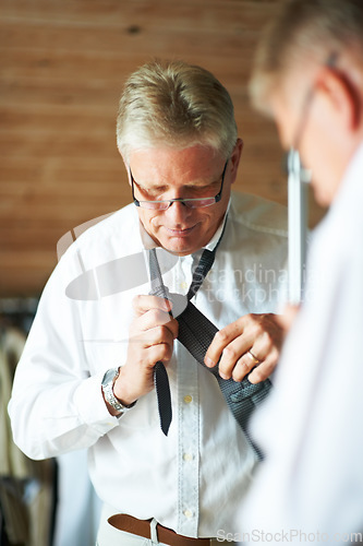 Image of Senior man with mirror, tie and shirt for work in morning in apartment with glasses, clothes and confidence. Face, reflection and professional mature businessman in home getting ready for office.