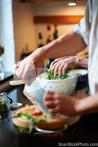 Image of Couple, hands cooking together and healthy food, love and marriage with fresh vegetables in home. Meal prep, man and woman at kitchen counter with support, diet and salad for dinner in apartment.