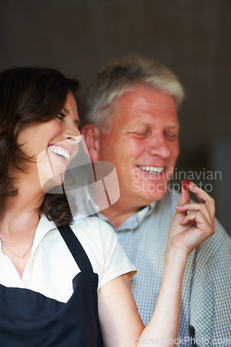 Image of Mature couple, laughing and cooking together with healthy food, love and marriage with fresh fruit in home. Meal prep, old man and woman in kitchen with eating, diet and salad for dinner in apartment