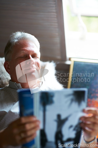 Image of Relax, magazine or senior man reading newspaper articles in home for information or story updates. Smile, book or mature person studying abstract art for knowledge in a publication in living room