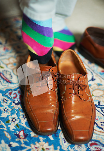 Image of Man getting ready, shoes and socks in home, putting on business fashion on foot and start to day. Businessman dressing for work in morning, feet on hotel room floor with style and wardrobe on carpet.