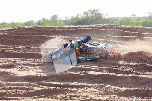 Image of Sand, accident and motorbike for sports with action for challenge or competition with power. Speed, mistake and desert with bike for race or adventure in outdoor with freedom or fearless driving.