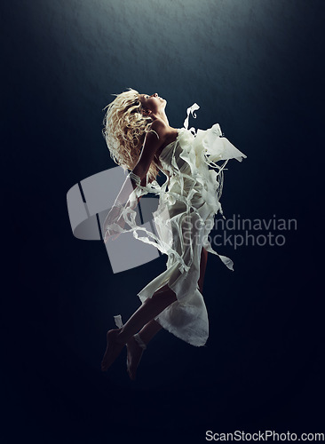 Image of Art, dance and a ballet woman floating underwater for creative expression or theater performance. Freedom, energy and stage with a young person training for a show or rehearsal on a black background