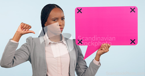 Image of Portrait, speech bubble and mockup with a business black woman pointing in studio on a gray background. Review, information or announcement and a young employee holding space with tracking markers