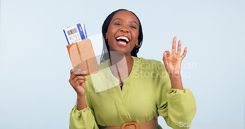 Image of Black woman, passport and ok sign for studio portrait with airplane ticket, documents and excited by blue background. Girl, paperwork and emoji for compliance, immigration and international travel