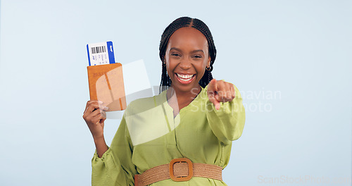 Image of African woman, passport and studio portrait to point at you for airplane ticket, document and smile by blue background. Girl, paperwork and emoji for compliance, immigration and international travel