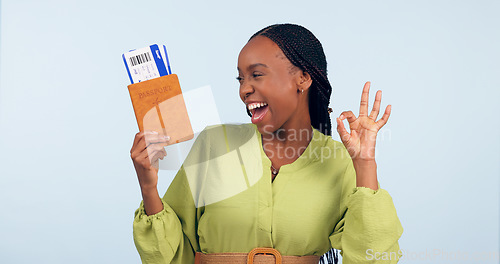 Image of African woman, passport and studio with ok sign for airplane ticket, documents or excited smile by blue background. Girl, legal paperwork and emoji for compliance, immigration or international travel