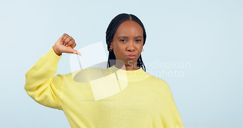 Image of Thumbs down, portrait and hands of woman in studio for rejection of bad news, complaint and no feedback on blue background. African model show emoji sign for review of wrong decision, icon or failure