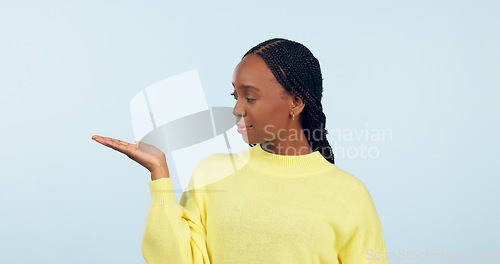 Image of Woman, palm and advertising space in studio of announcement, mockup or promotion on blue background. African model show hand for presentation of choice, decision or feedback of deal, opinion or offer