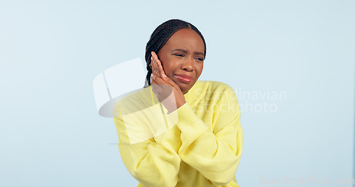 Image of Black woman, toothache and inflammation with pain, unhappy and uncomfortable on isolated studio background. Dental problem, teeth and mouth for cavity, sore and pressure with hands, gums or infection