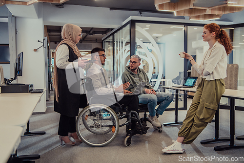 Image of Young group of business people brainstorming together in a startup space, discussing business projects, investments, and solving challenges.