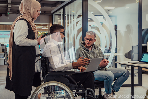 Image of Young group of business people brainstorming together in a startup space, discussing business projects, investments, and solving challenges.