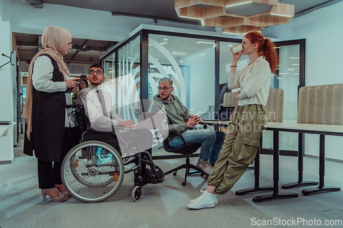 Image of Young group of business people brainstorming together in a startup space, discussing business projects, investments, and solving challenges.