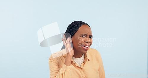 Image of Woman, hand and ear in studio for gossip, story and frustrated face in portrait by blue background. African girl, hearing and confused for secret information, news and communication with questions