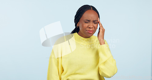 Image of Woman, pain and headache in studio for stress, challenge and fatigue of mental health on blue background. African model massage temple for anxiety, brain fog or tired of migraine, vertigo and burnout