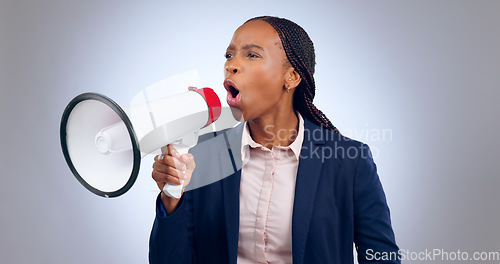 Image of Megaphone, speech and angry business woman in studio for change, transformation or freedom on grey background. Corporate, justice and female speaker with bullhorn noise for announcement attention