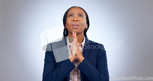 Image of Praying, religion and black woman in a studio for gratitude, forgiveness and hope compassion. Blessing, spiritual and young African female person with prayer hand gesture isolated by gray background.