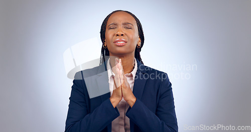 Image of Praying, spiritual and black woman in a studio for gratitude, forgiveness and hope compassion. Blessing, religion and young African female person with prayer hand gesture isolated by gray background.