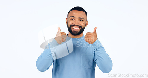 Image of Thumbs up, man and portrait with sign for yes in studio, white background with happiness, support. Thank you, hands and person smile for success, agreement or positive emoji with achievement of goal