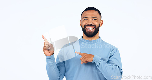 Image of Man, portrait and pointing in studio for advertising information, deal or choice on white background. Happy model, presentation or show mockup space for feedback, promotion or launch of news about us