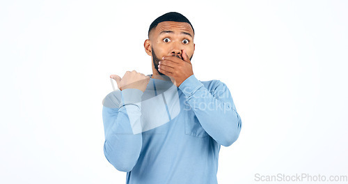 Image of Shock, pointing and portrait of man in a studio with wow, omg or wtf facial expression for news. Surprise, emoji and face of young male person from Colombia isolated by white background with mockup.