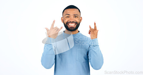 Image of Happy man, rocker and hands with smile in studio with portrait for mockup on white background. Male model, face and excited in freedom, fun or party for energy of music, sign or punk gesture in space