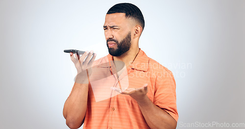 Image of Man in studio with phone, voice call and frustrated with connection problem for communication. Discussion, anger and confused person on smartphone conversation, scam or phishing on white background.