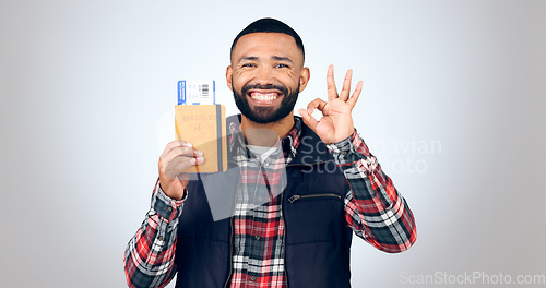 Image of Ok sign, portrait and man with a passport, smile and vacation on white studio background. Face, model and tourist with tickets, perfect symbol and travelling with mockup space, agreement and holiday