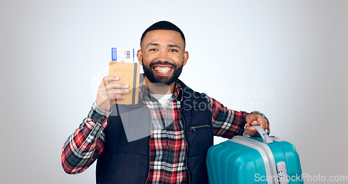 Image of Travel, portrait and man with a passport, suitcase and vacation with a smile on white studio background. Face, model and tourist with tickets, luggage and travelling with mockup space and holiday