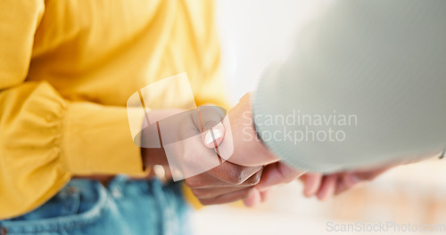 Image of Couple, closeup and holding hands in house together for support, bonding and love with care for communication. People, helping and link for empathy, kindness and connection with trust in apartment