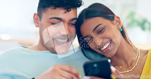 Image of Couple, phone and relax on couch, laugh or reading for funny story, notification or post on web blog. Man, woman and smartphone for meme, streaming comic video or happy on social media app in home