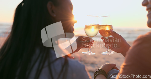 Image of Sunshine, beach and couple with wine, toast and anniversary with happiness, marriage or vacation. Romance, man or woman with alcohol, cheers or relationship with seaside holiday, lens flare or summer