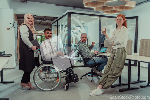 Image of Young group of business people brainstorming together in a startup space, discussing business projects, investments, and solving challenges.