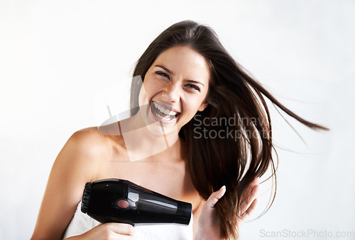 Image of Woman, smile and blow drying hair with hairdryer, style and heat treatment or blowout, beauty and appliance. Happy female person, haircare and portrait by white background, cosmetic and mockup