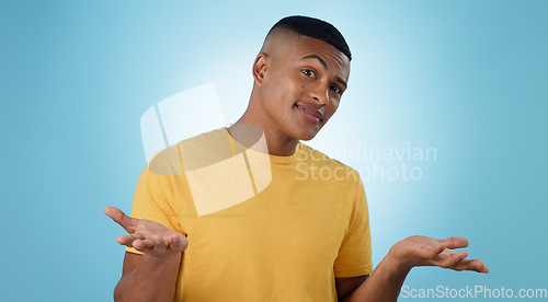 Image of Confused, portrait and man shrug in studio with why hands on blue background space. Doubt, face and model with dont know emoji for choice, decision or palm scale, questions or asking body language