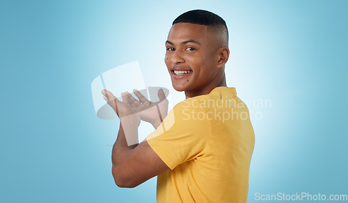 Image of Man, portrait and studio for advertising presentation, information or deal on blue background. Happy model show mockup space for feedback, sales promotion coming soon or offer launch of news about us