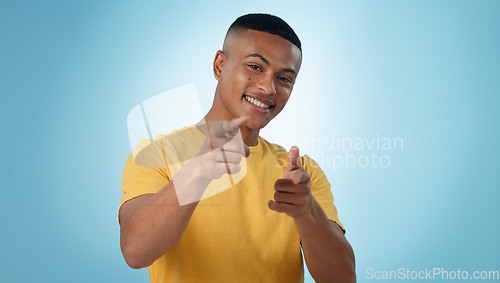 Image of Happy man, portrait and pointing to you for choice, selection or hiring against a blue studio background. Male person or model and finger for decision, choose or opportunity in recruiting on mockup