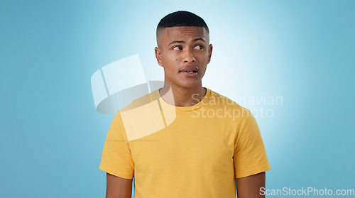 Image of Thinking, doubt or problem solving and a man on a blue background in studio with a question on mockup. Confused, idea or why with a young person on space for planning or brainstorming a solution