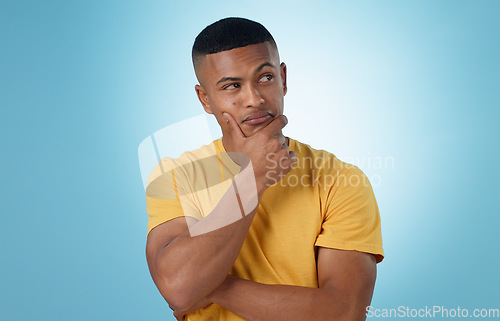 Image of Man, face and thinking in decision, choice or planning for idea or memory against a blue studio background. Unsure male person or curious model in wonder, remember or solution in why, emoji or mockup