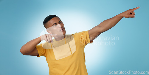 Image of Pointing, announcement or man by offer, discount deal or sale on studio space or advertising. Breaking news, show or male person with mockup for guide, menu choice or promotion on blue background