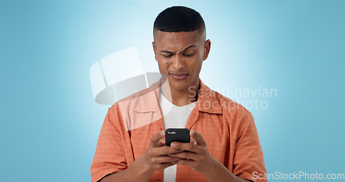 Image of Expression, confused and man with a smartphone, typing and connection on a blue background. Person, guy and model with a cellphone, mobile user and reaction with doubt, error 404 and contact with app